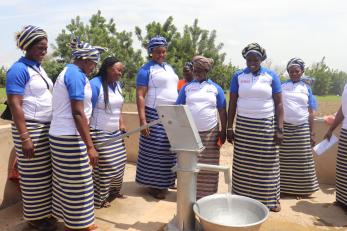 A group of people holding a reception for a new waterpoint.