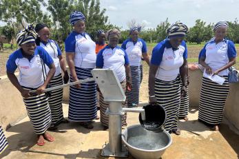 Project participants work together at a community well.